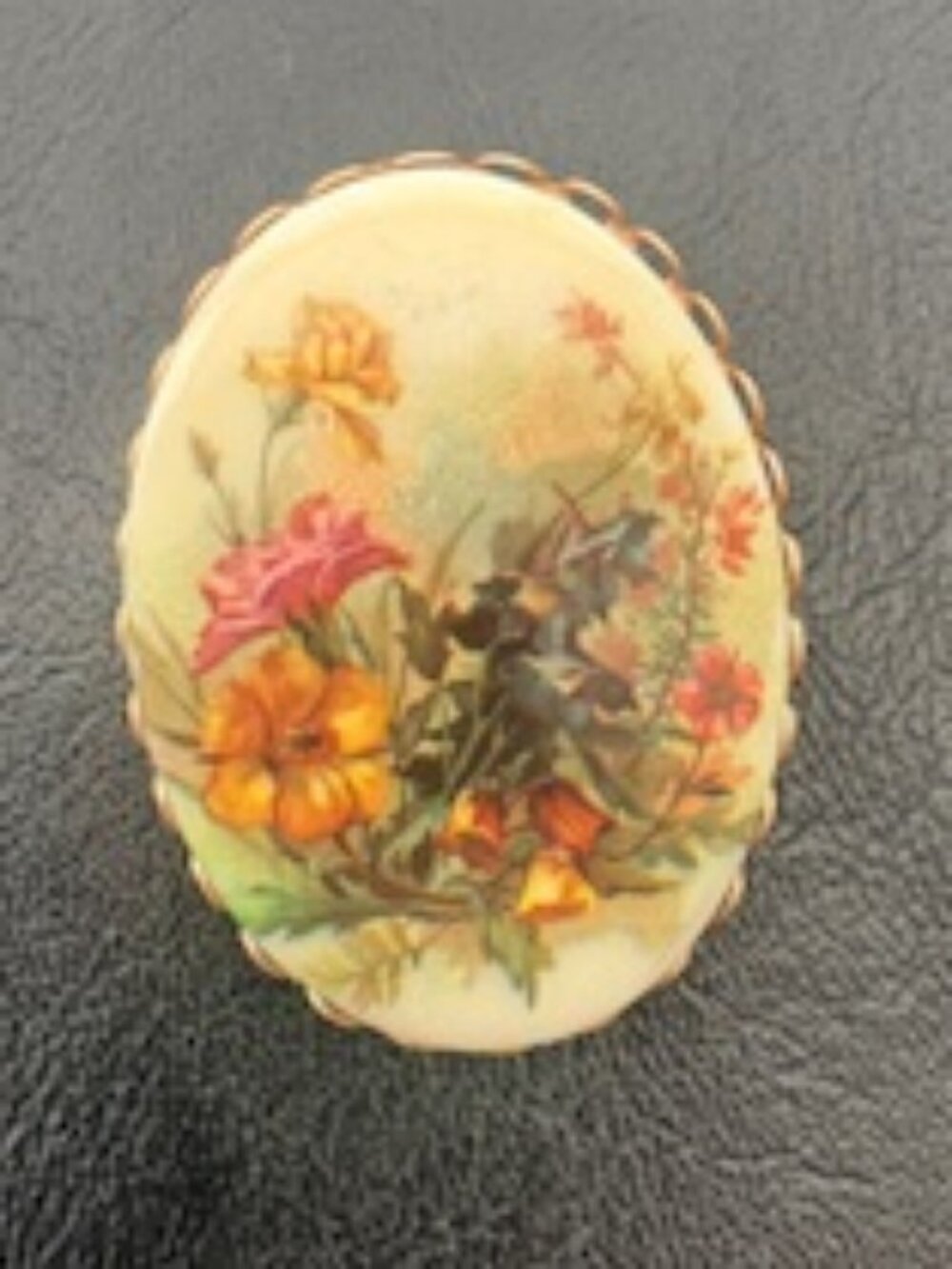 Porcelain transferware brooch-Floral scene-Gold tone filigree frame.